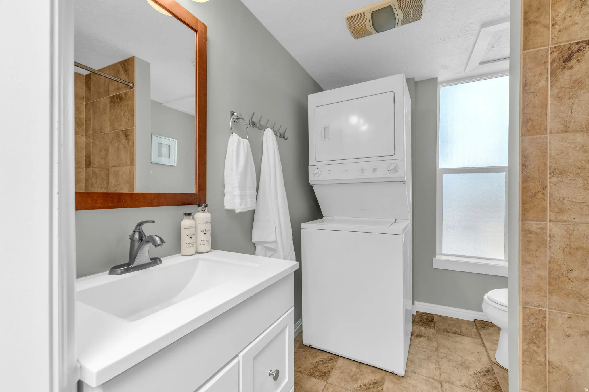 Vanity with an integrated sink and brushed nickel faucet