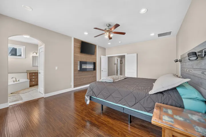 Wood-finish flooring, recessed lighting, and a ceiling fan