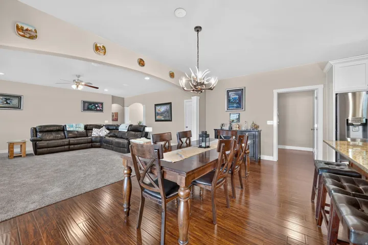 Wood-finish flooring, recessed lighting, and a decorative chandelier