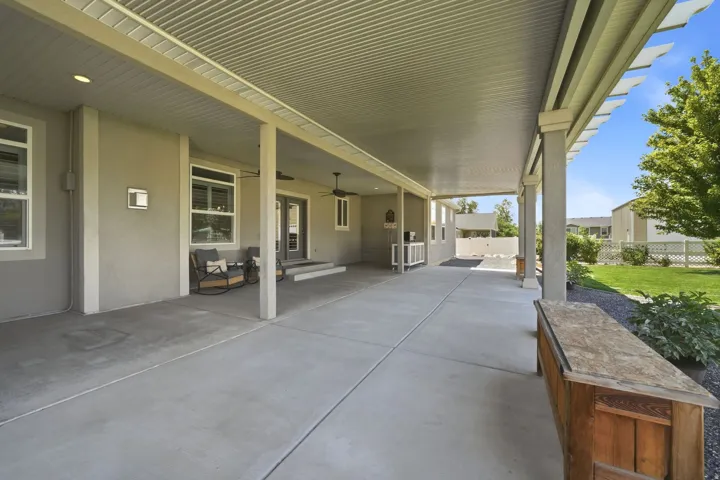 Expansive covered patio with recessed lighting and ceiling fans