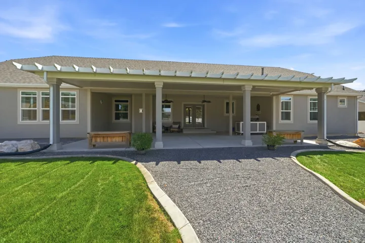 Covered patio with a pergola-style roof, multiple columns, and a concrete surface