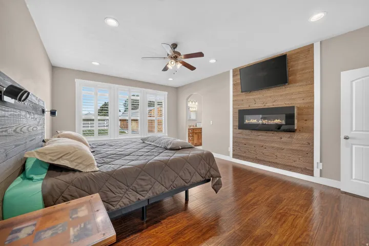 Wood-finish flooring, recessed lighting, and a ceiling fan