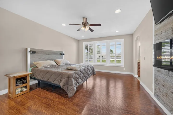 Wood-finish flooring, recessed lighting, and a ceiling fan