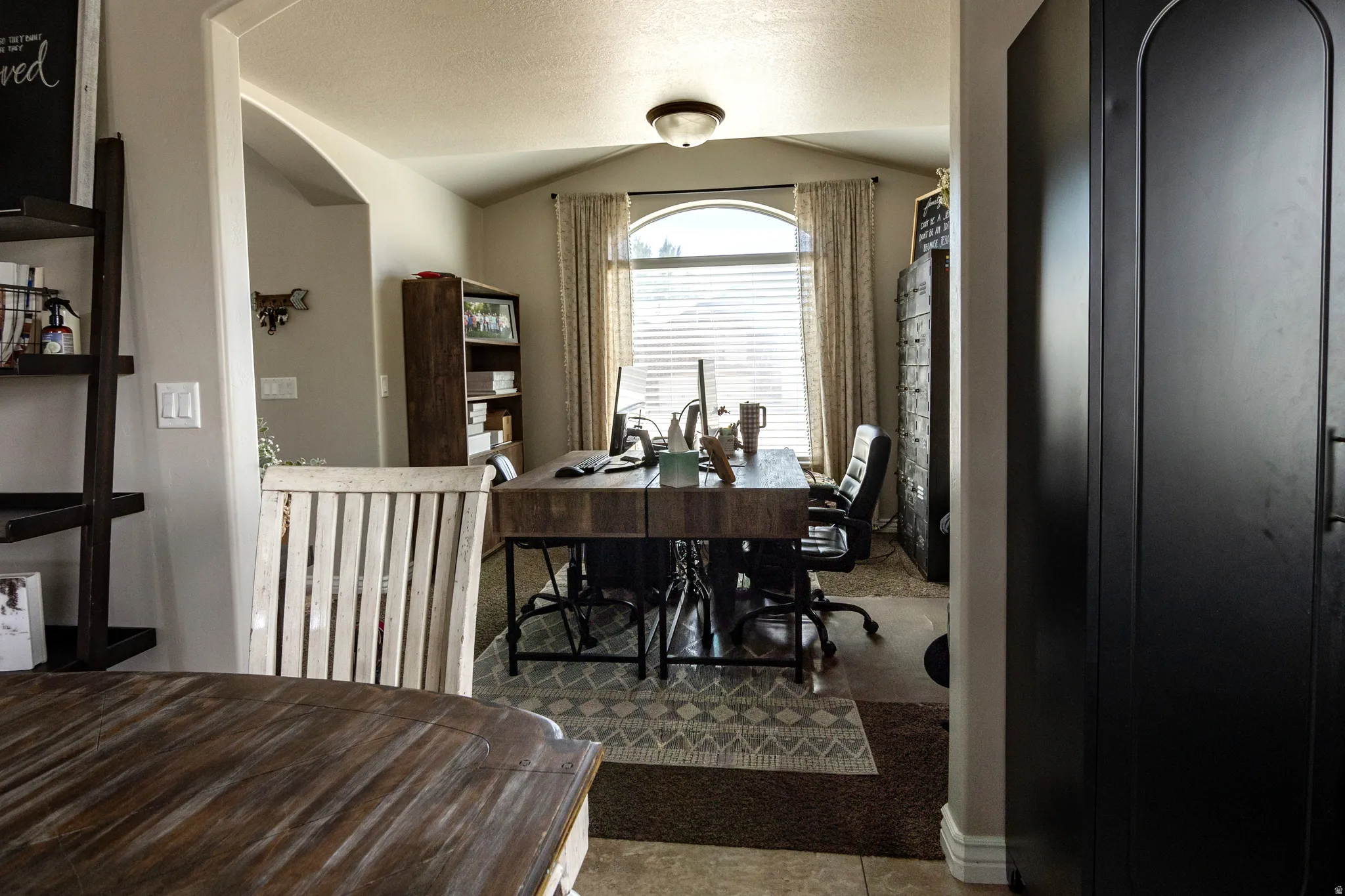 Archway entry to a room with a large arched window
