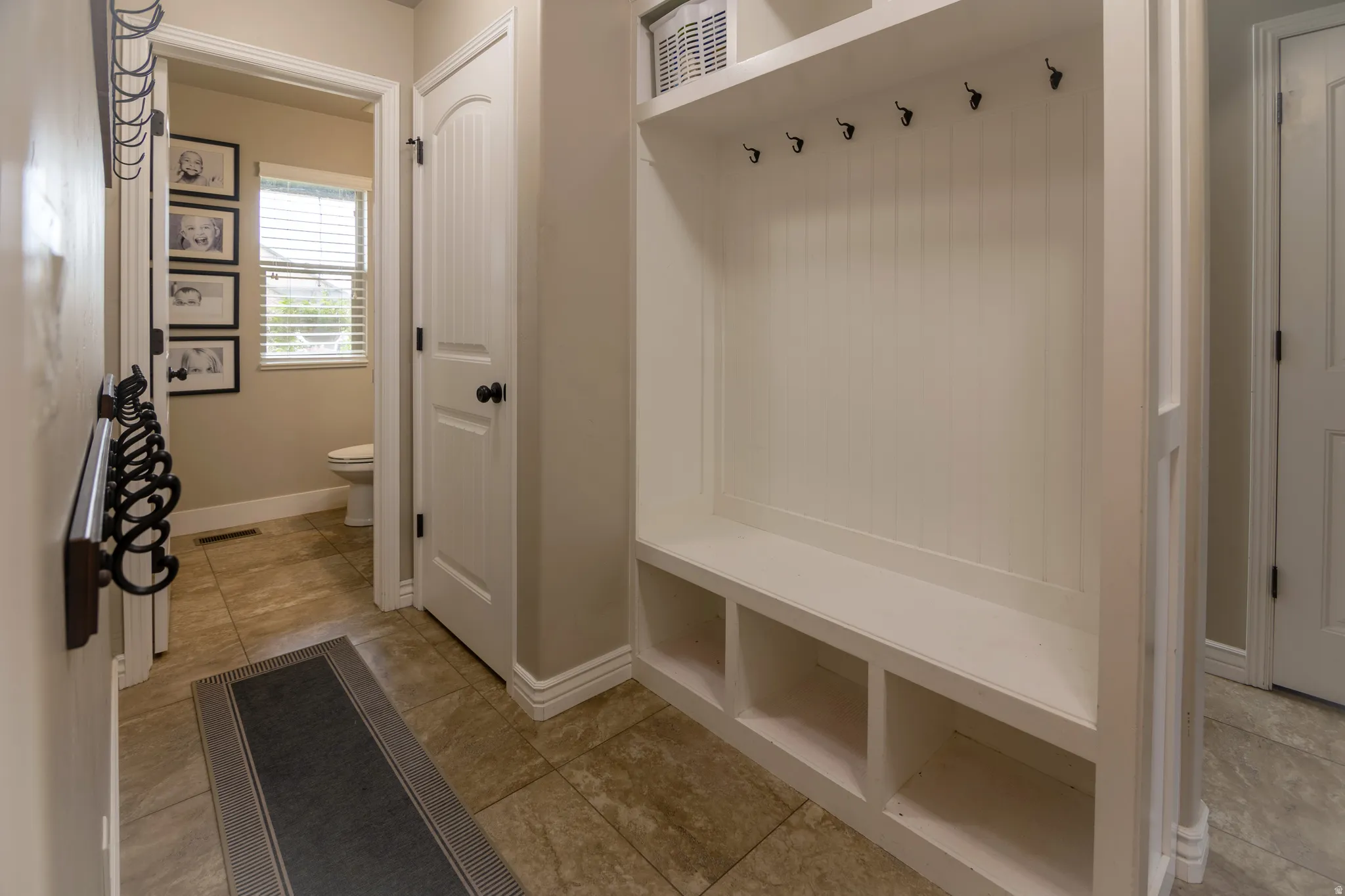 Built-in mudroom bench with cubby storage and coat hooks