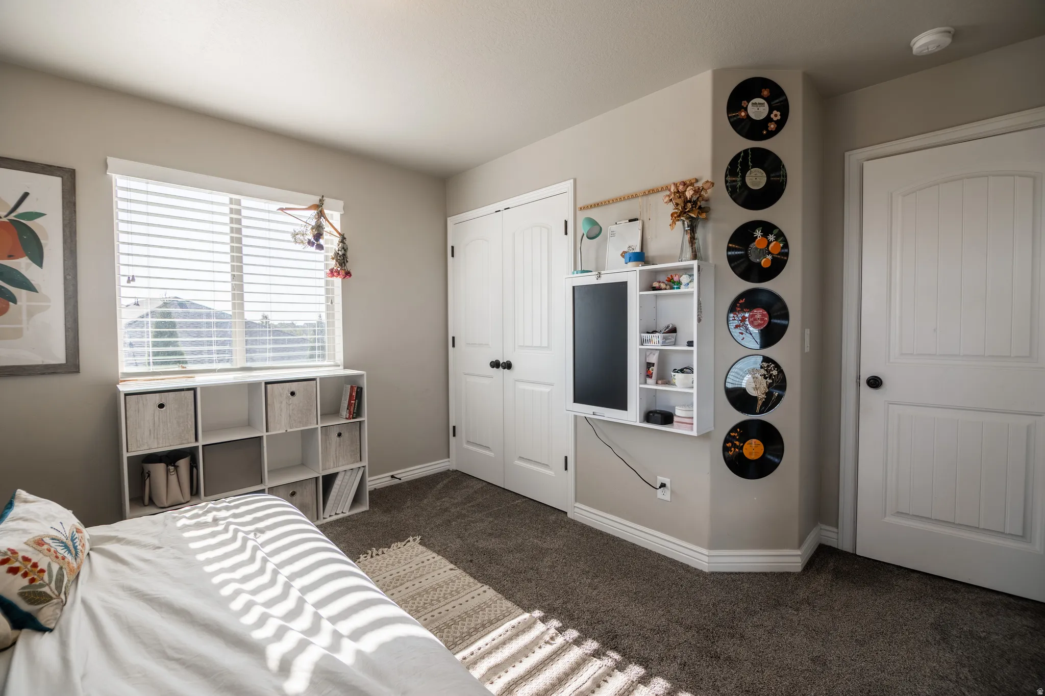 Window with horizontal blinds, neutral wall paint, and plush carpet flooring