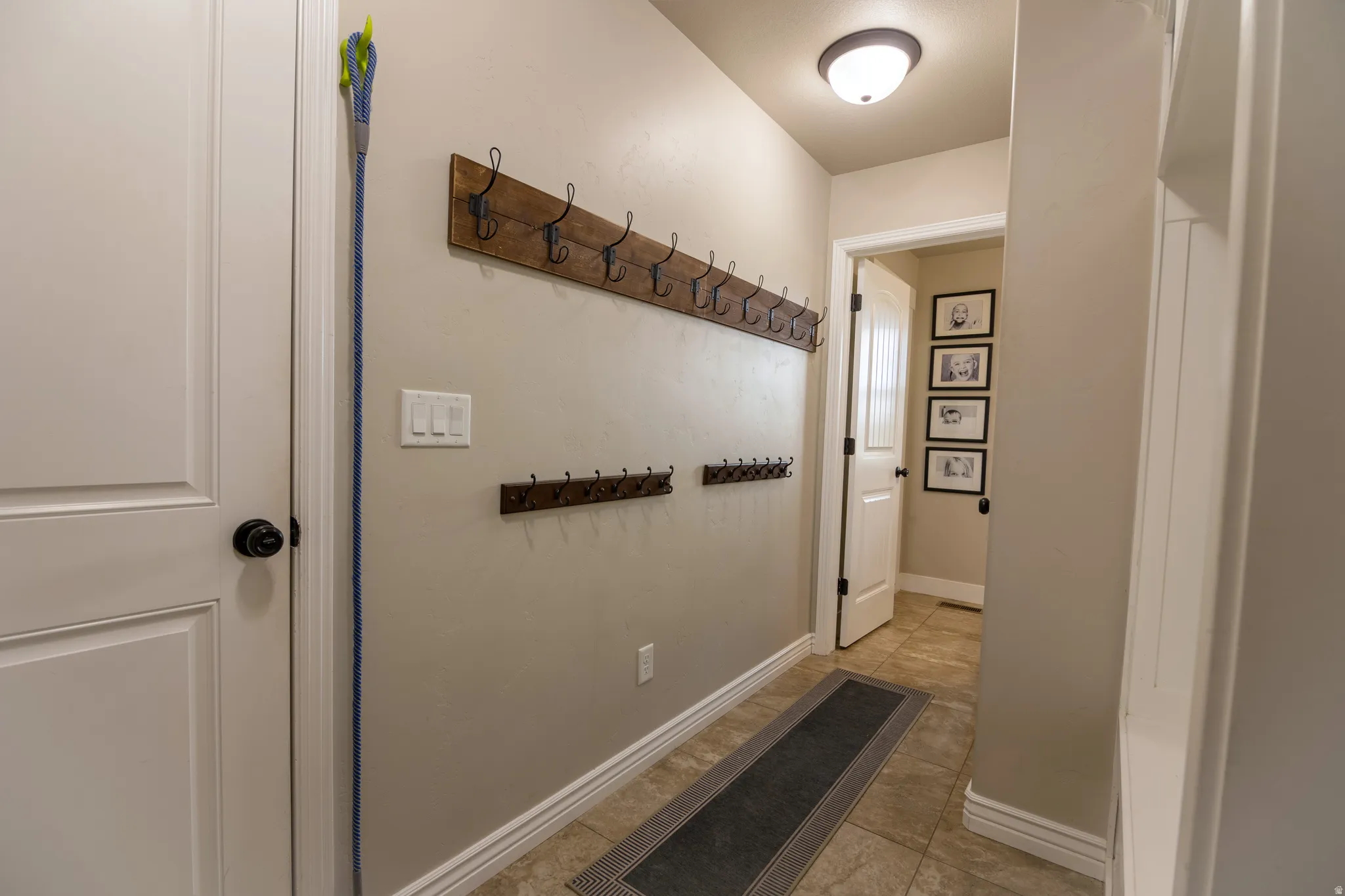Recessed ceiling light fixture, two-panel interior doors, light-toned wall paint, and tile flooring