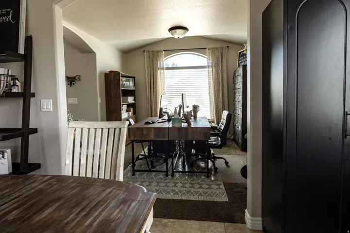 Archway entry to a room with a large arched window