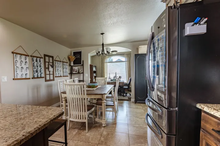 Tile flooring with a light grout, archway entry, and a built-in arch window with horizontal blinds