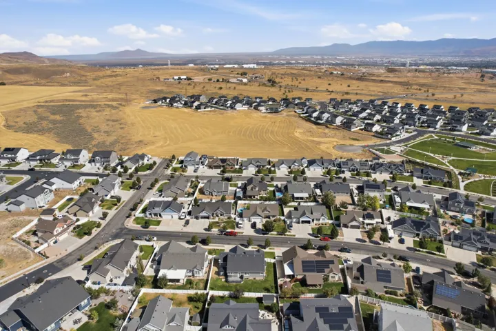 Expansive residential development with a mountain backdrop and varied rooflines