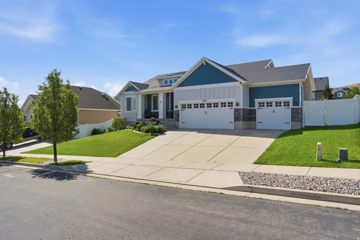 Contemporary exterior featuring mixed material siding, a multi-car garage, and a concrete driveway