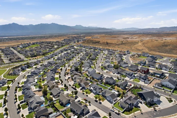 Expansive residential development featuring numerous homes with varied rooflines and landscaping