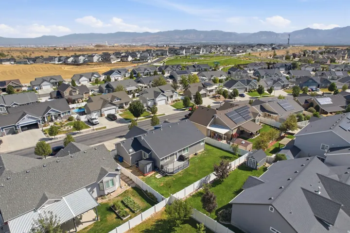 Residential community featuring single-family homes, manicured lawns, and paved streets