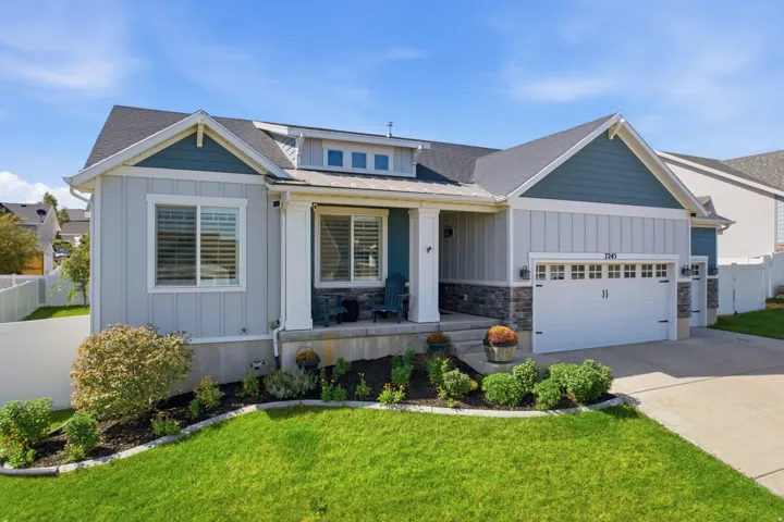 Contemporary exterior with board and batten siding, stone veneer accents, and an attached two-car garage