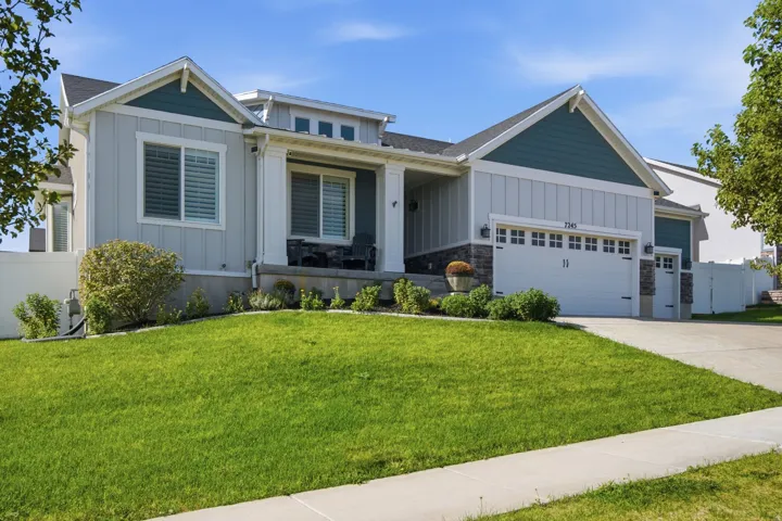 Contemporary exterior with vertical and horizontal siding accents, an attached two-car garage, and a covered porch
