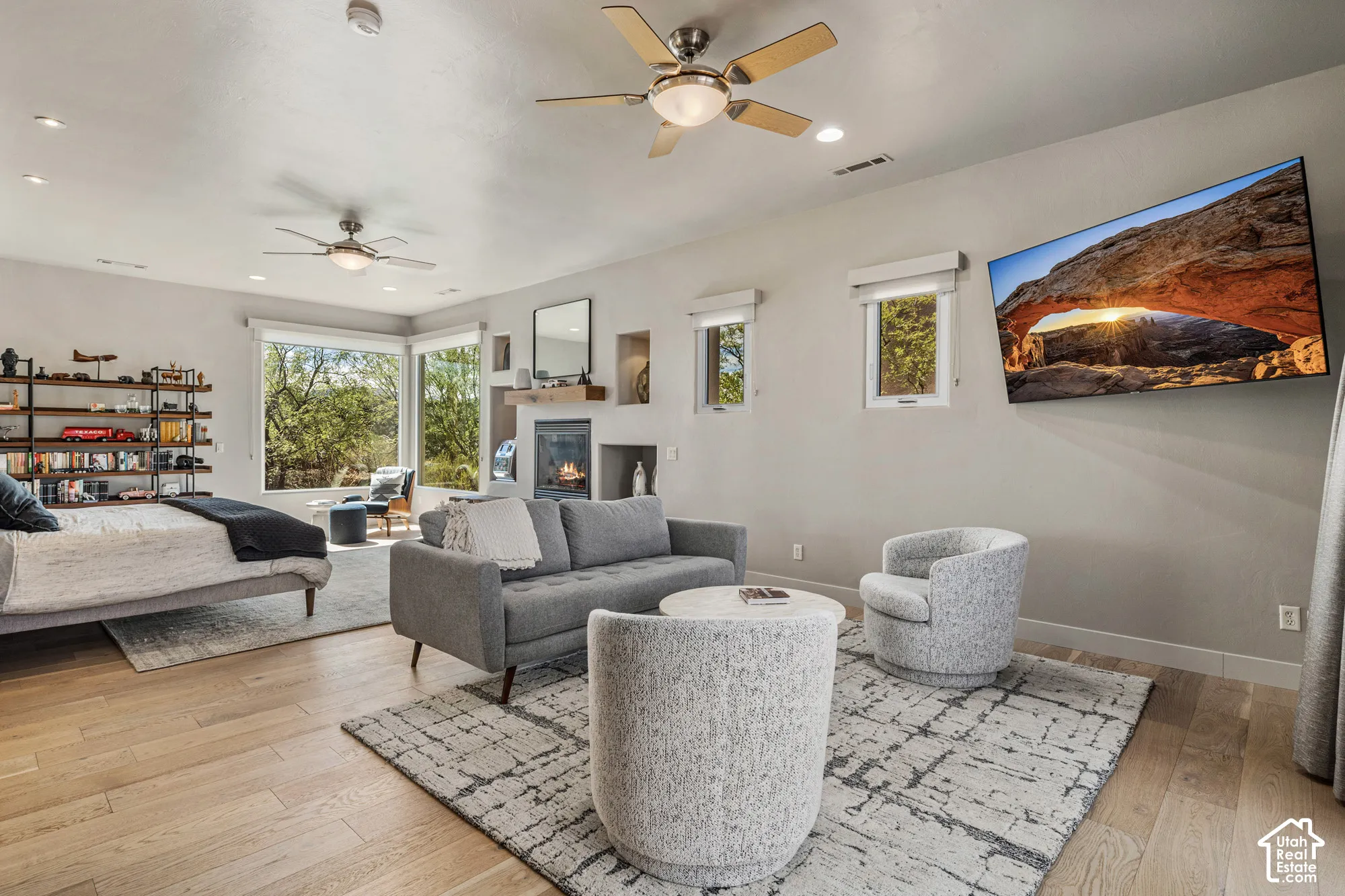 Hardwood-finish flooring, built-in shelving, and a fireplace with a wood mantle