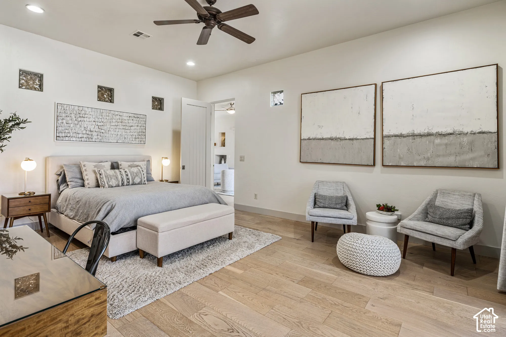 Spacious room featuring wood-finish flooring, recessed lighting, and a ceiling fan