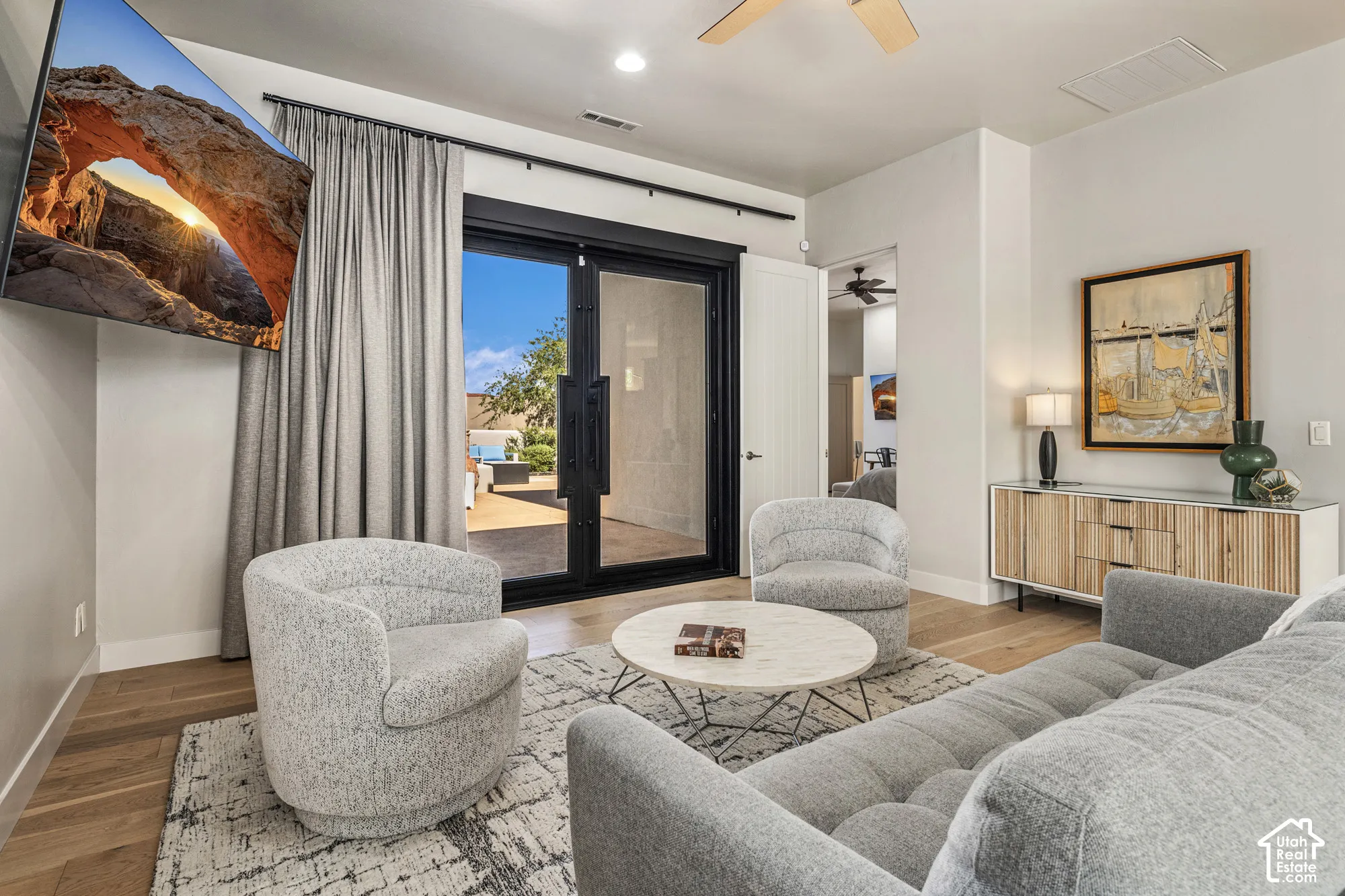 Wood-finish flooring throughout, complemented by a ceiling fan and recessed lighting