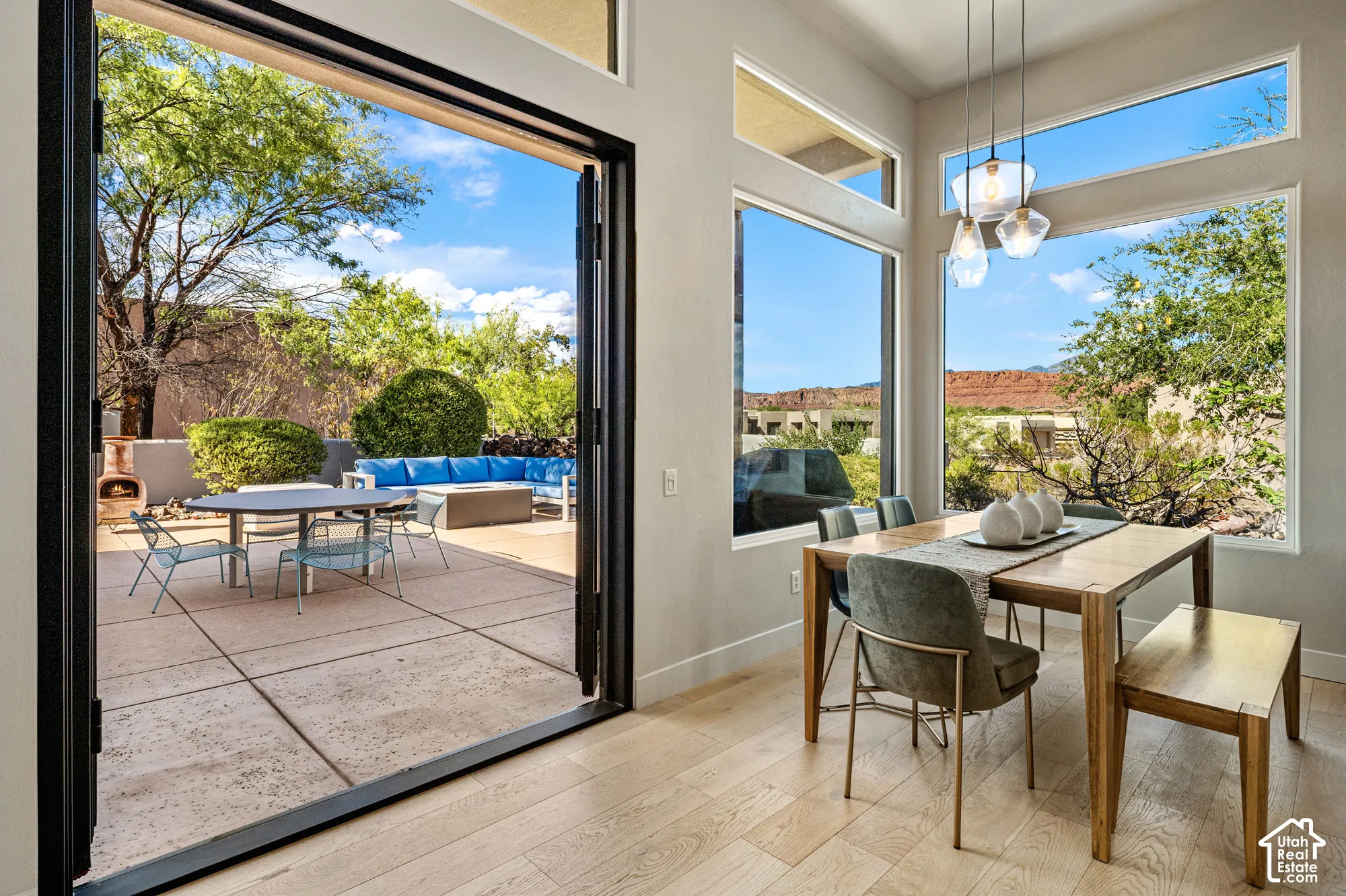 Expansive patio with stone hardscaping, framed by a multi-panel folding glass door system