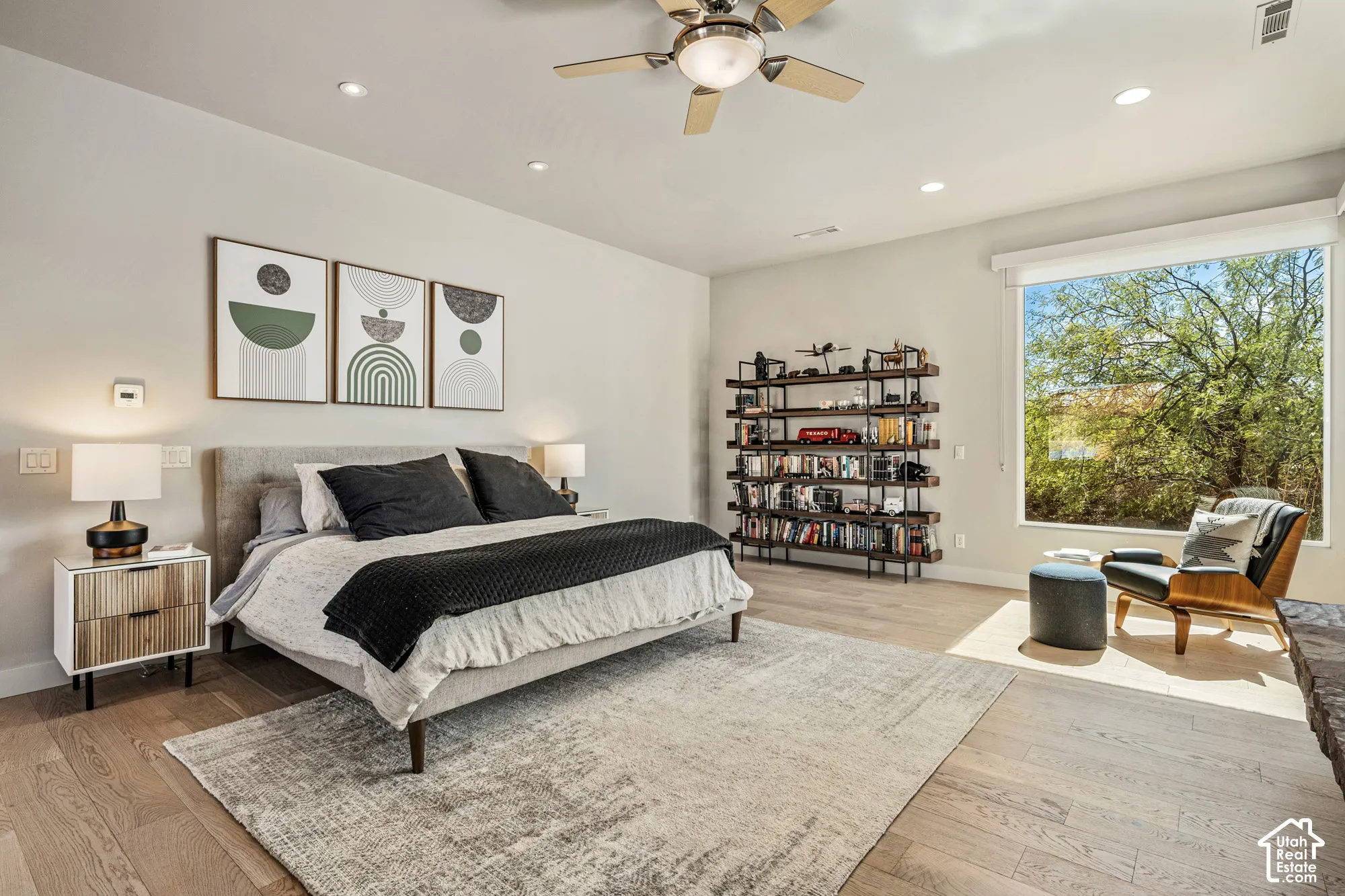 Recessed lighting, wood-finish flooring, and a ceiling fan create a comfortable atmosphere