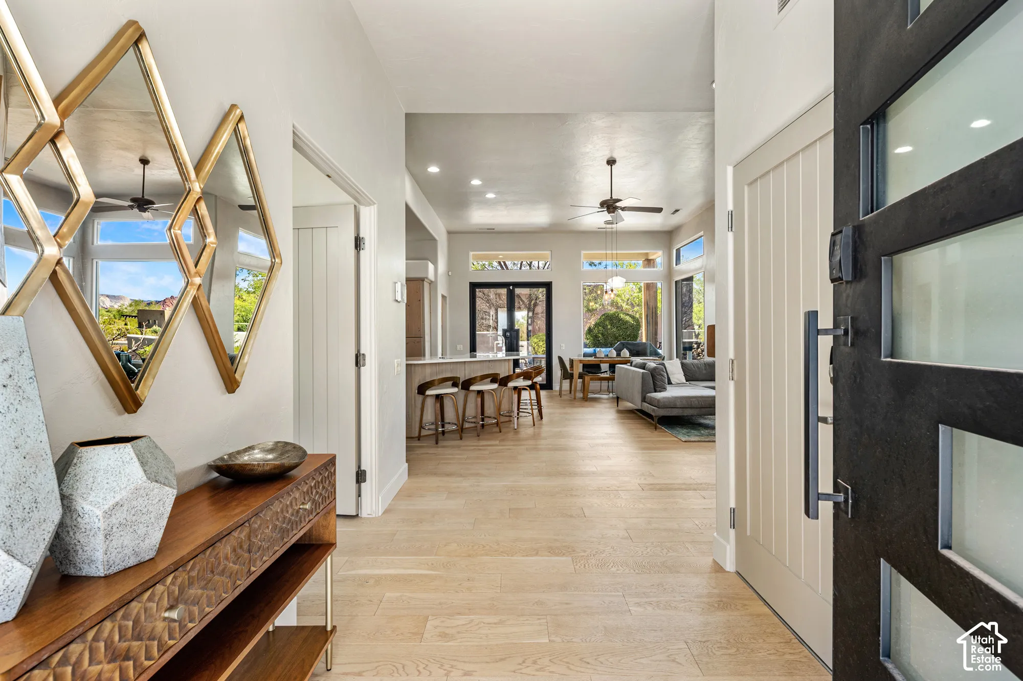 Wide plank wood-finish flooring, recessed lighting, and a modern ceiling fan