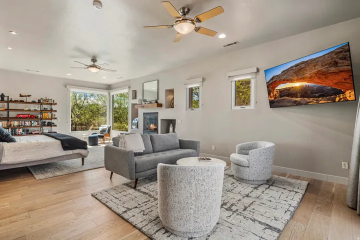 Hardwood-finish flooring, built-in shelving, and a fireplace with a wood mantle