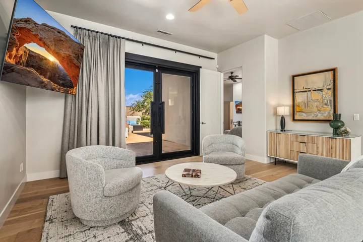 Wood-finish flooring throughout, complemented by a ceiling fan and recessed lighting