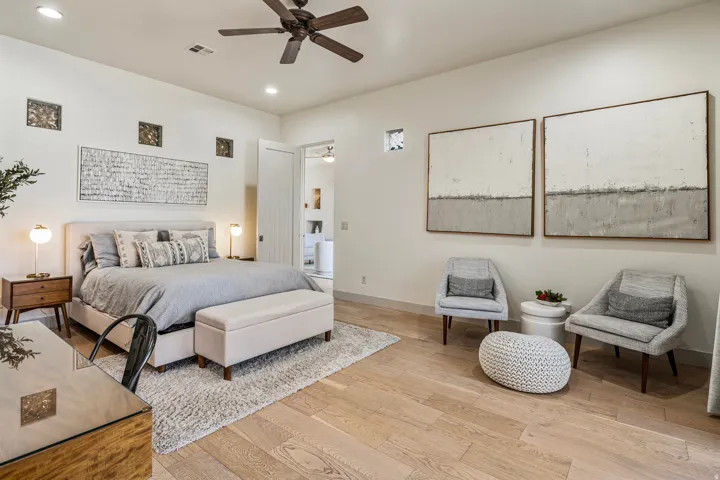 Spacious room featuring wood-finish flooring, recessed lighting, and a ceiling fan