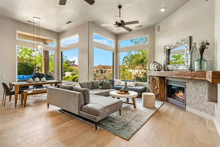 Vaulted ceilings, wood-finish flooring, and a fireplace with a decorative mantel