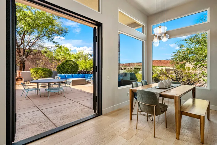 Expansive patio with stone hardscaping, framed by a multi-panel folding glass door system