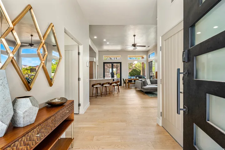 Wide plank wood-finish flooring, recessed lighting, and a modern ceiling fan
