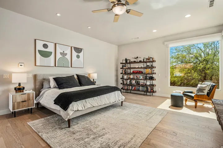 Recessed lighting, wood-finish flooring, and a ceiling fan create a comfortable atmosphere