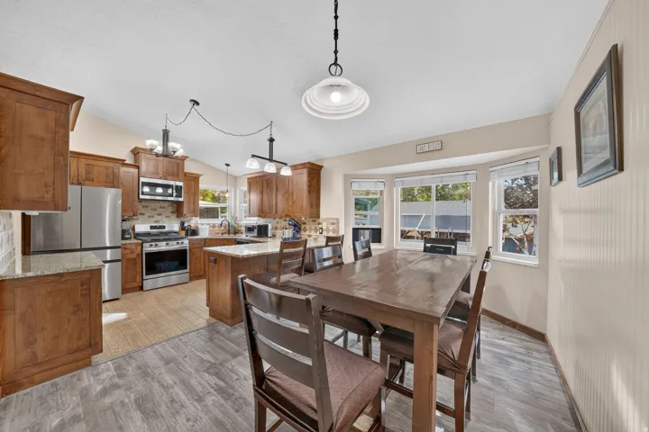 Kitchen featuring wood cabinetry, stainless steel appliances, and light-toned countertops