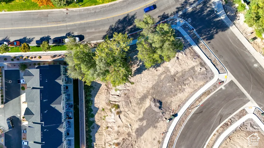 New construction site with adjacent residential buildings and paved roadways