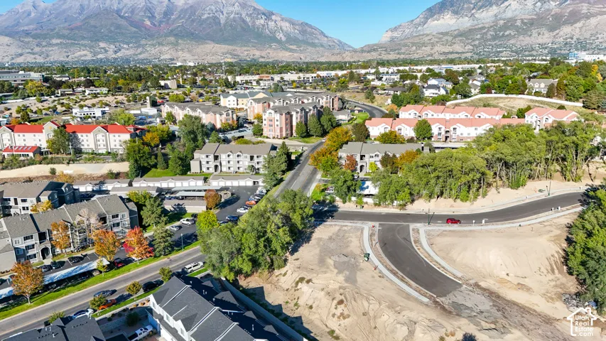 Mountain backdrop with established residential areas and new road construction