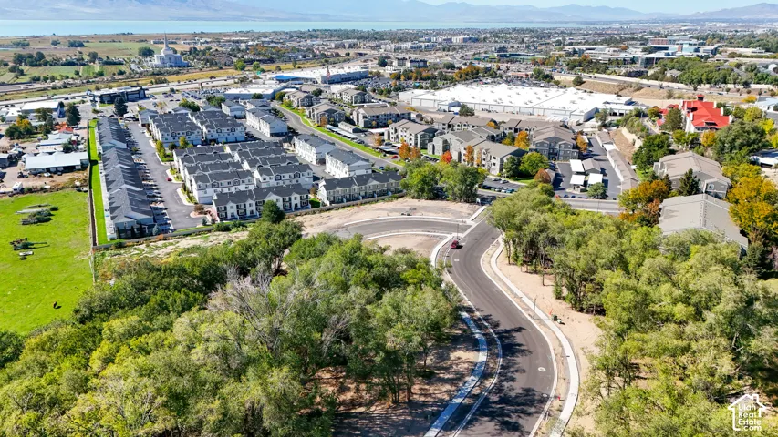 Residential neighborhood featuring multi-story townhomes with dark gray roofing