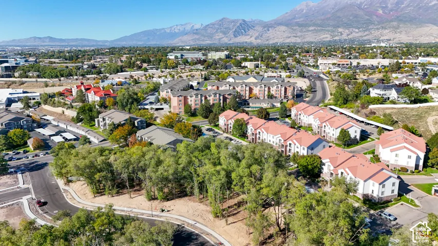 Expansive residential community featuring multiple buildings with red tile roofs and white facades