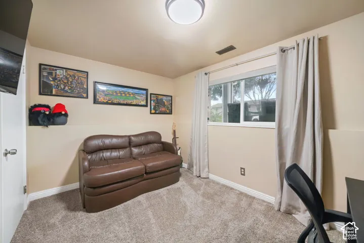 Wall-to-wall carpeting with a neutral finish, light-toned walls, and a white framed window