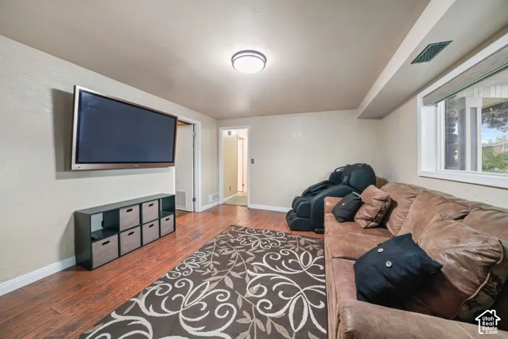 Recessed ceiling lighting, wood-finish flooring, and a large window with white trim