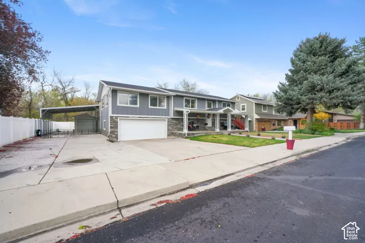 Two-story residence featuring a two-car garage, covered entry, and an extended driveway