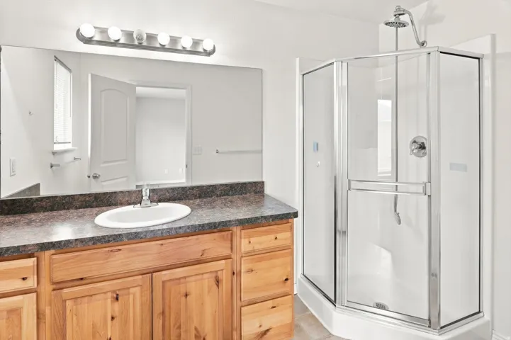 Wood-finish vanity with an integrated sink and laminate countertop