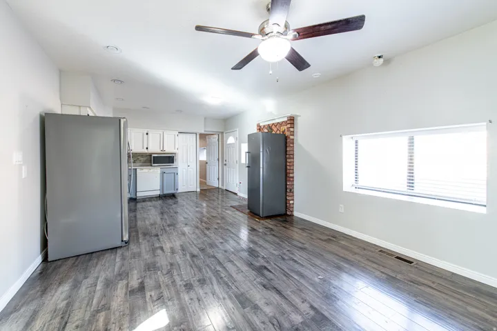 Wood-finish flooring, recessed lighting, and a ceiling fan with integrated light fixture