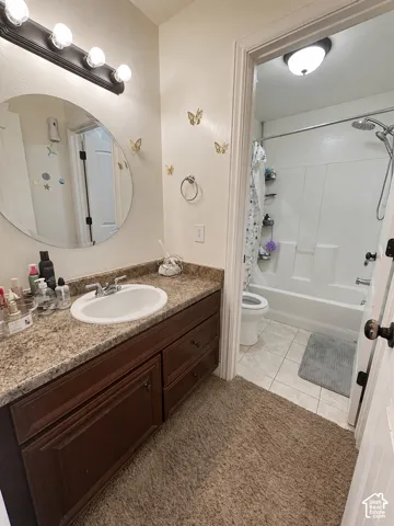 Vanity with an integrated basin, granite-finish countertop, and wood-panel cabinetry