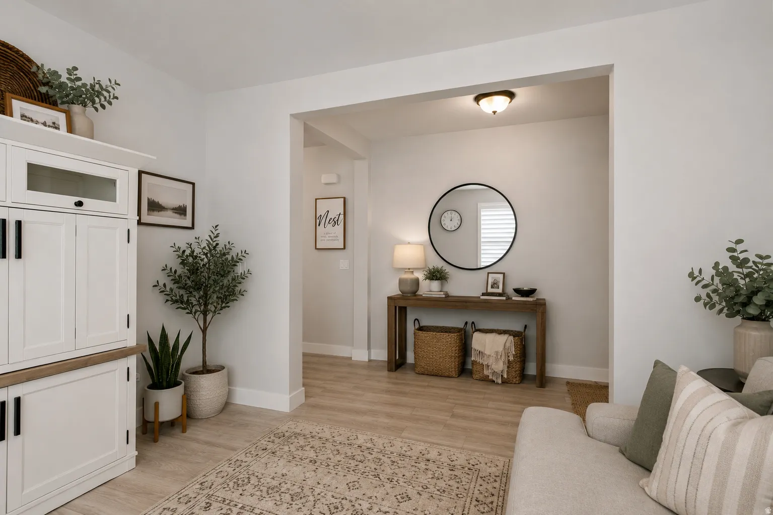 Open doorway with a decorative console table, recessed ceiling light fixture, and wood-finish flooring