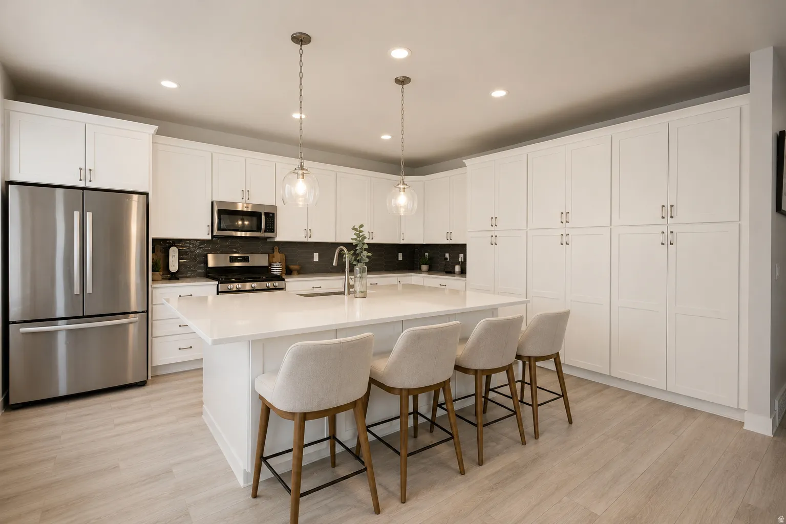 Kitchen featuring an expansive center island with seating, extensive white cabinetry, stainless steel appliances, a dark tile backsplash, and wood-finish flooring
