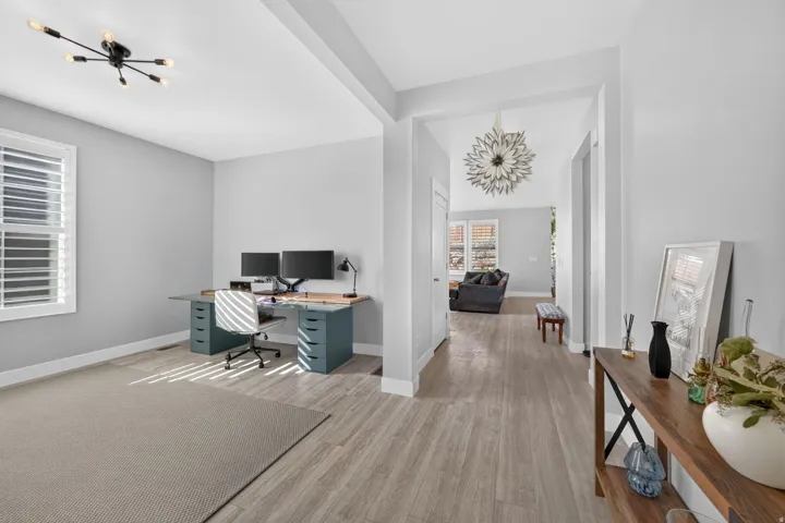 Recessed lighting, wood-finish flooring, and white plantation shutters