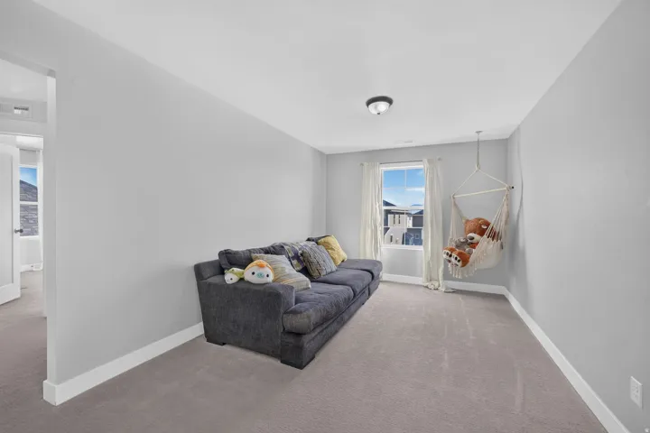 Neutral wall finishes, recessed window, carpeted flooring, white trim, and overhead lighting