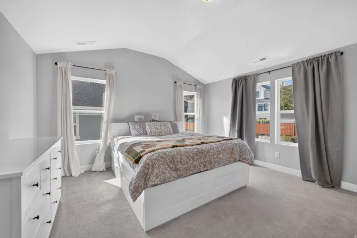 Vaulted ceiling, two large windows, two smaller windows, and light gray wall paint