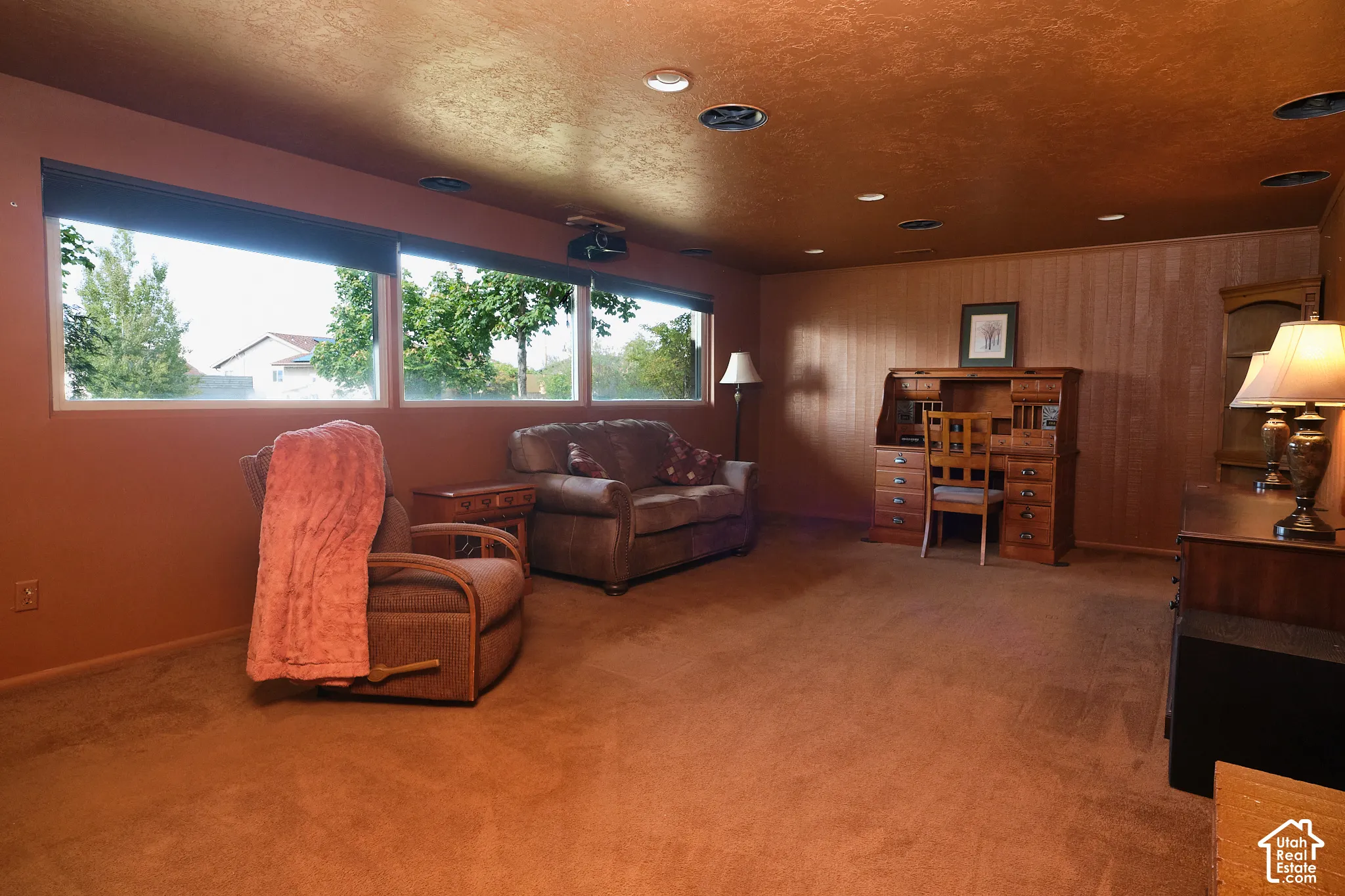 Wall-to-wall carpeting and a wall of windows