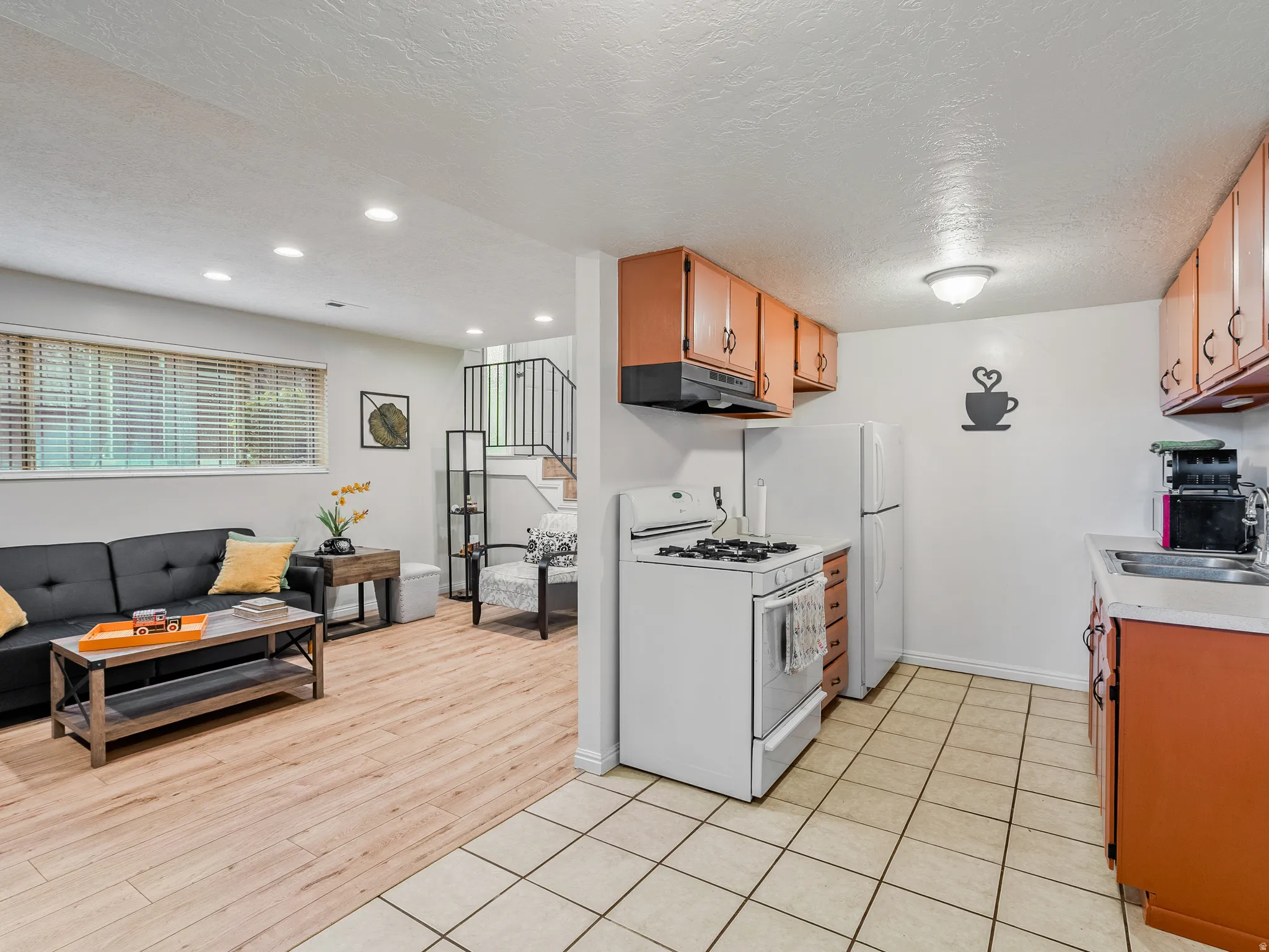 Kitchen with tile flooring and wood-finish cabinetry